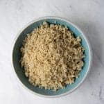 fluffy cooked quinoa piled in a bowl