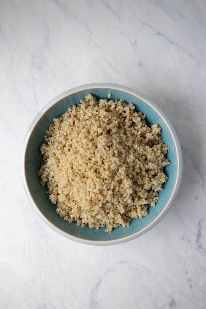 fluffy cooked quinoa piled in a bowl