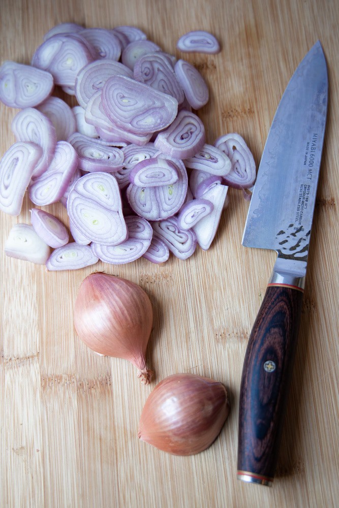 pile of sliced shallots on a cutting board