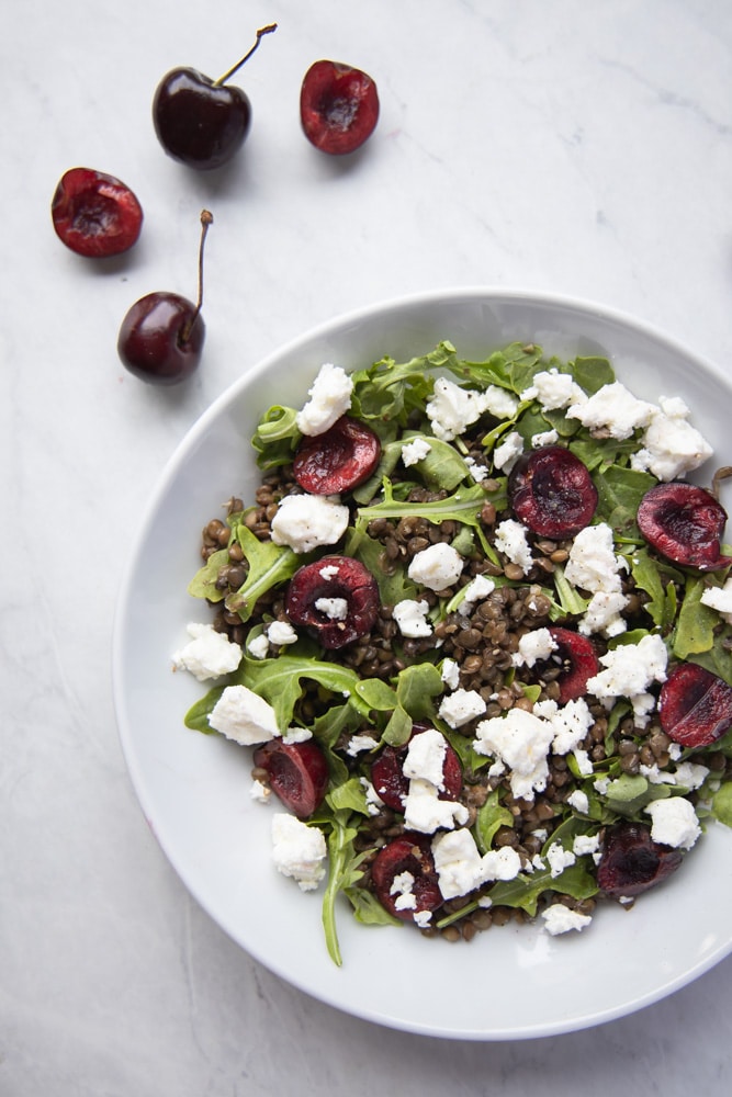 white bowl filled with cherry lentil salad