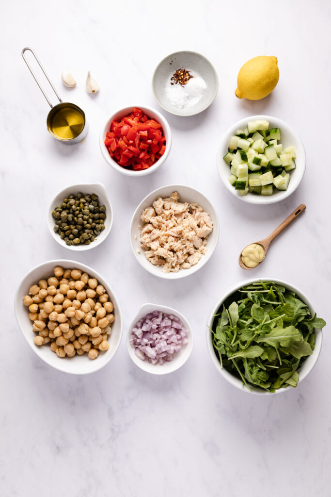 Ingredients to make tuna salad in individual bowls.