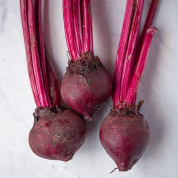 close up image of three red beets
