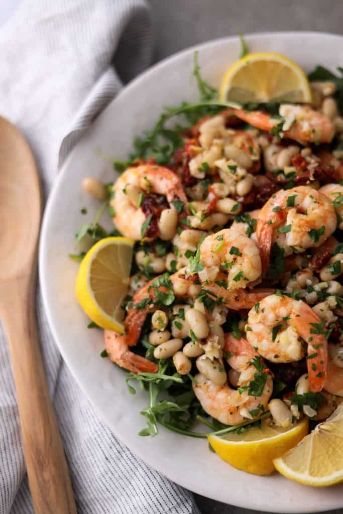 close up of shrimp and bean salad on platter