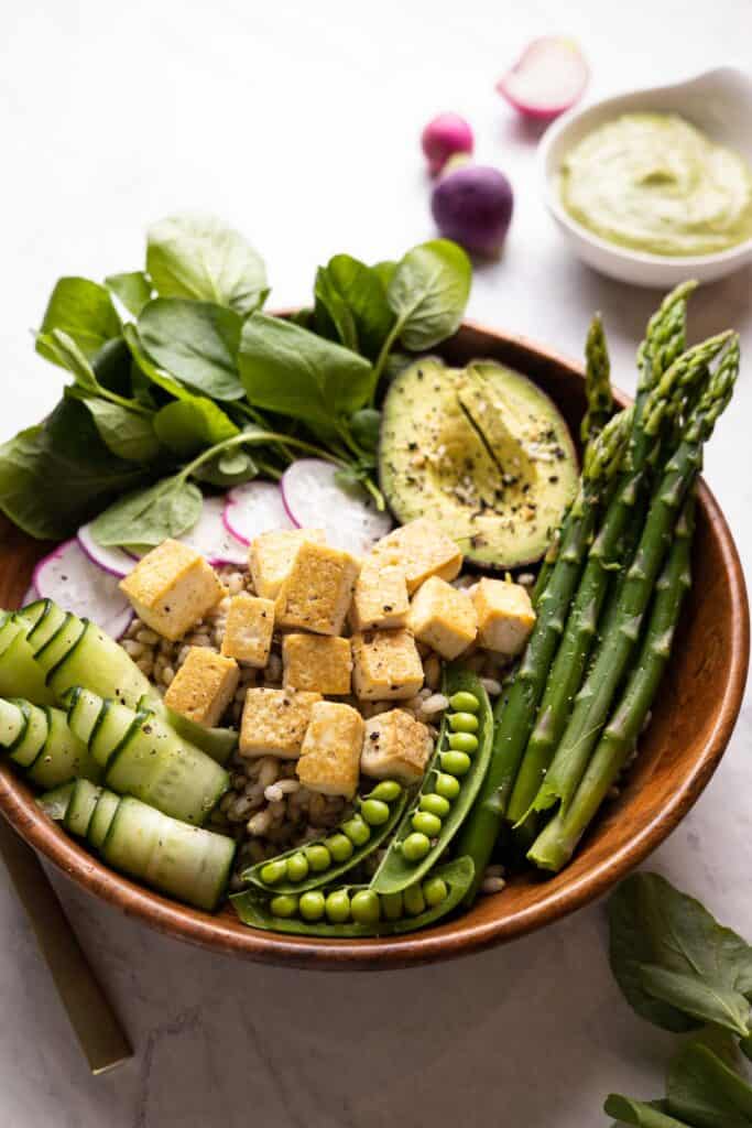 wooden bowl filled with spring grain bowl