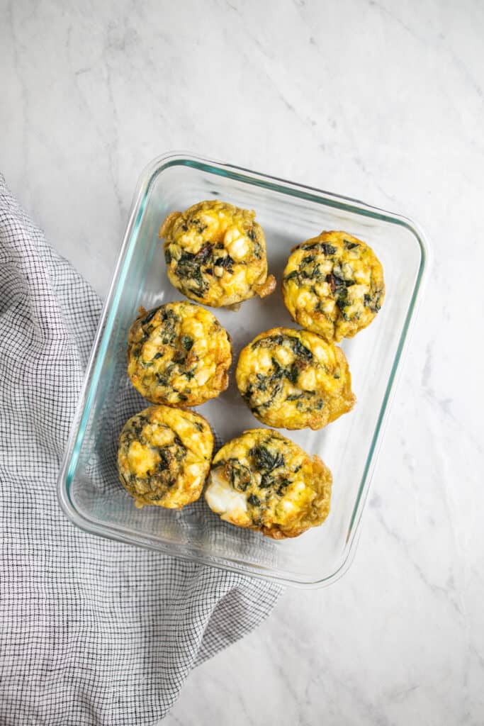 swiss chard and feta egg bites in a glass meal prepcontainer