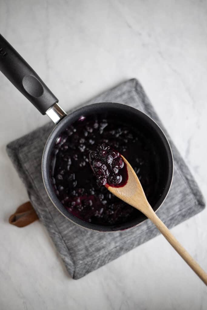 saucepot of blueberry compote reduced down
