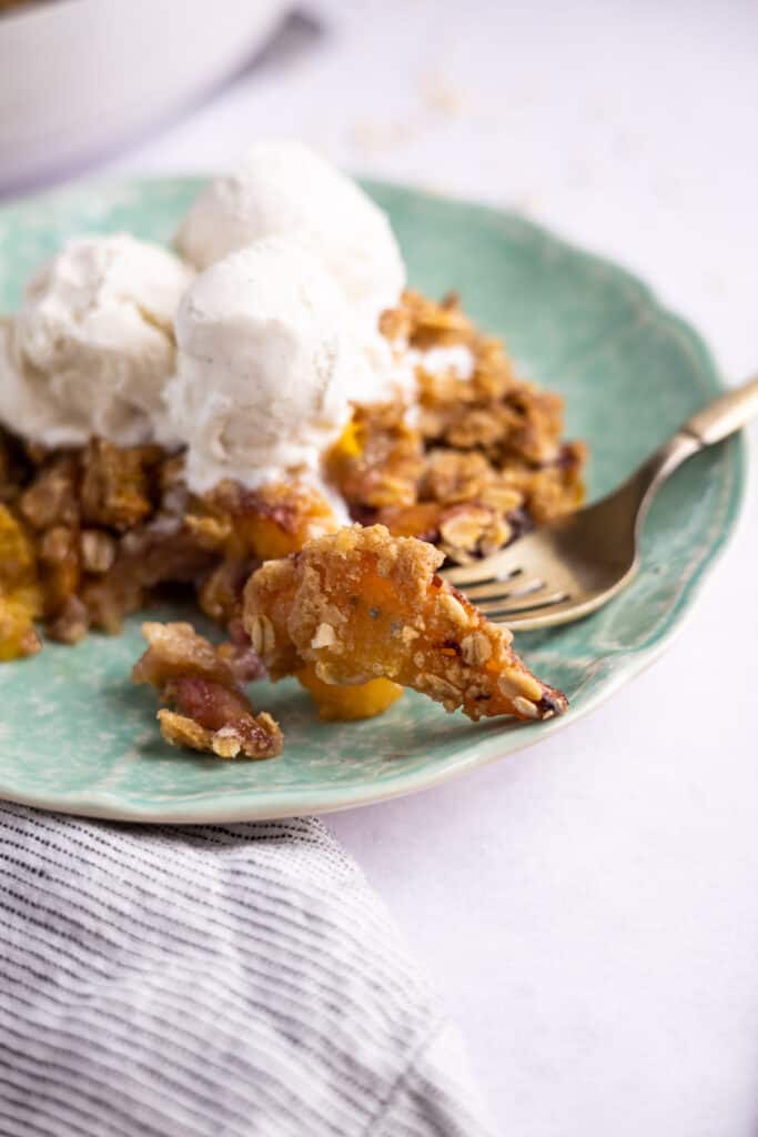 close up of nectarine crumble on a fork