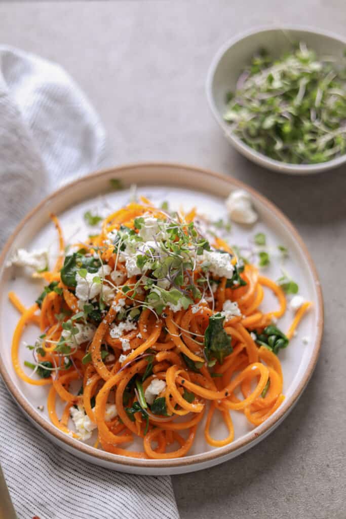 butternut squash noodles on a plate topped with goat cheese