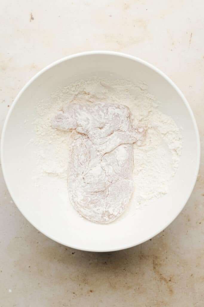 Chicken breast dredged in flour.